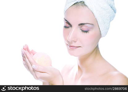 Lovely young woman with aroma bath ball in her hands. Toned in blue