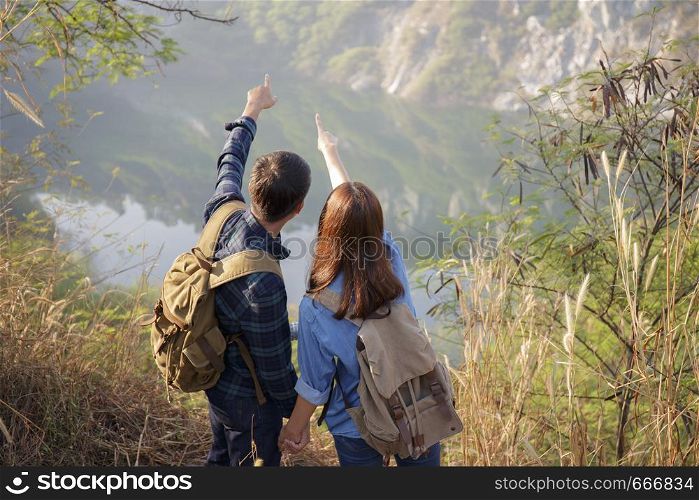 Lovers are enjoying the scenic view, young Asian tourists.