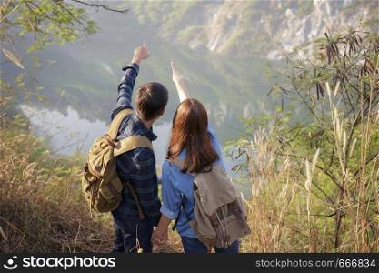 Lovers are enjoying the scenic view, young Asian tourists.