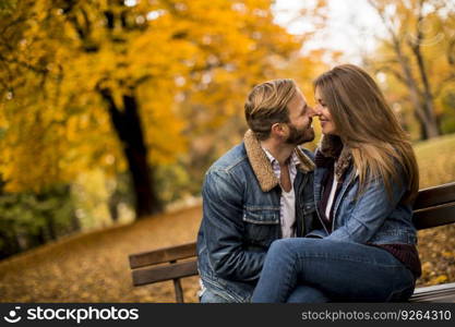 Lovers are sitting on a bench in the city park