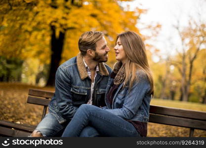 Lovers are sitting on a bench in the city park