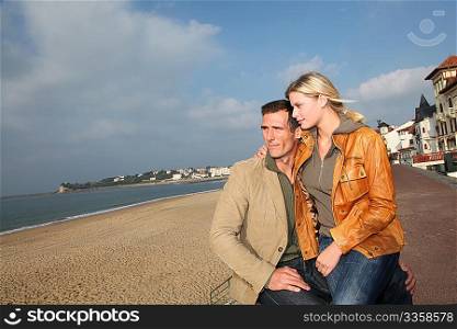 Lovers at the beach in autumn