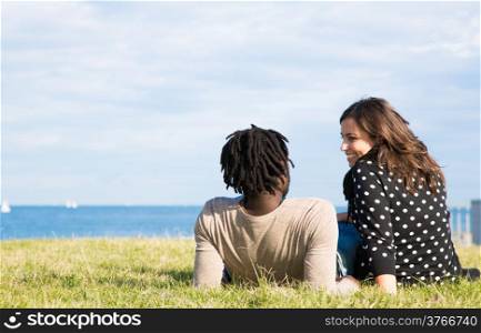 Lovers back in the grass next to the beach