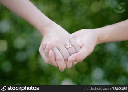 Lovers couple holding hands with bokeh background for friendship and love concept&#xA;