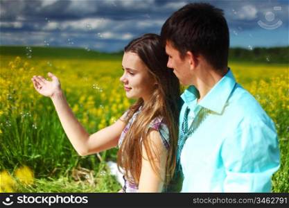 lovers hug on yellow flower field