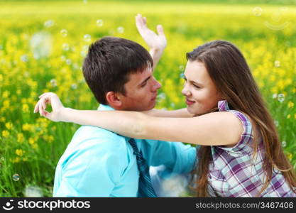 lovers hug on yellow flower field