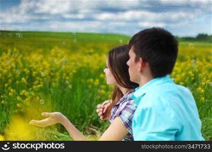 lovers hug on yellow flower field