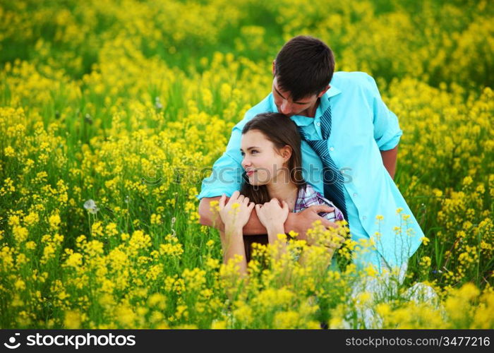 lovers hug on yellow flower field