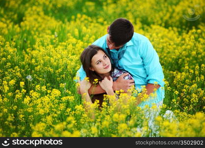 lovers hug on yellow flower field