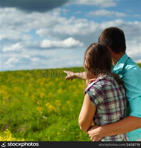 lovers look around on yellow flower field