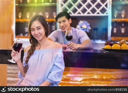 Lovers smiling and drinking for honeymoon at bar. Couple and Relax concept. Night honeymoon theme