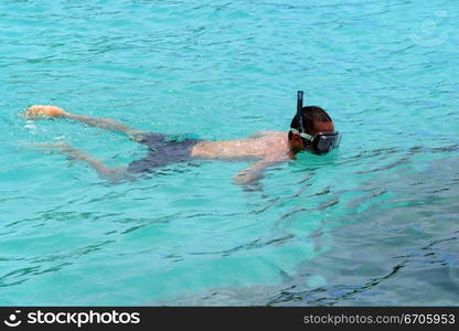 Lovers snorkel in the pristine waters of Koh Tao, tranquil, tranquility, tropical, paradise, pristine, tropical, heaven, delight, joy, haven, retreat, sanctuary, oasis, Thailand.