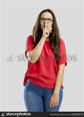 Lovey woman with her finger on her lips and asking for silence