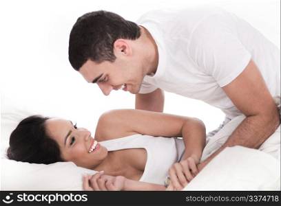 Loving affectionate couple in bed over white background