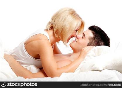 Loving affectionate heterosexual couple on bed.