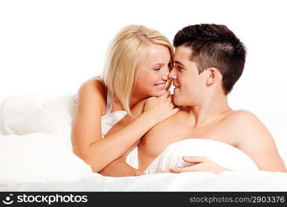 Loving affectionate heterosexual couple on bed.