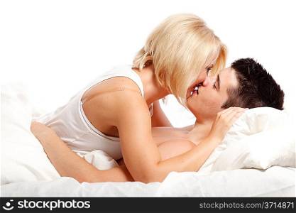 Loving affectionate heterosexual couple on bed.
