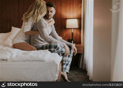 Loving and hugged couple on the bed in the room