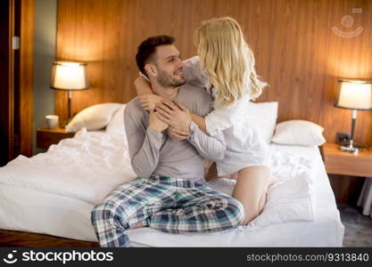 Loving and hugged couple on the bed in the room