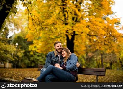 Loving and romantic couple on a bench in the autumn park