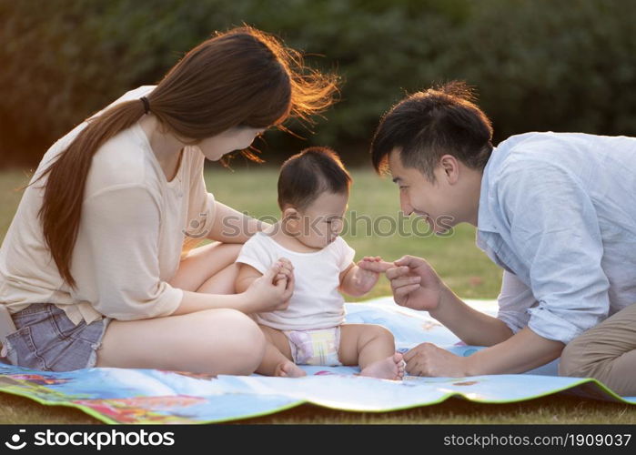 Loving and warm young family under the sunset