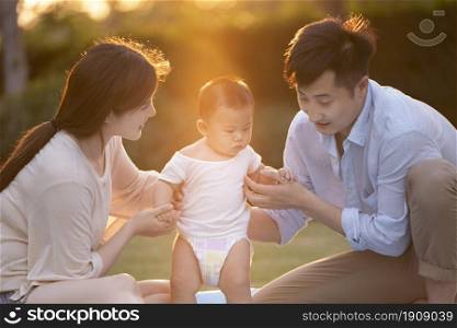 Loving and warm young family under the sunset
