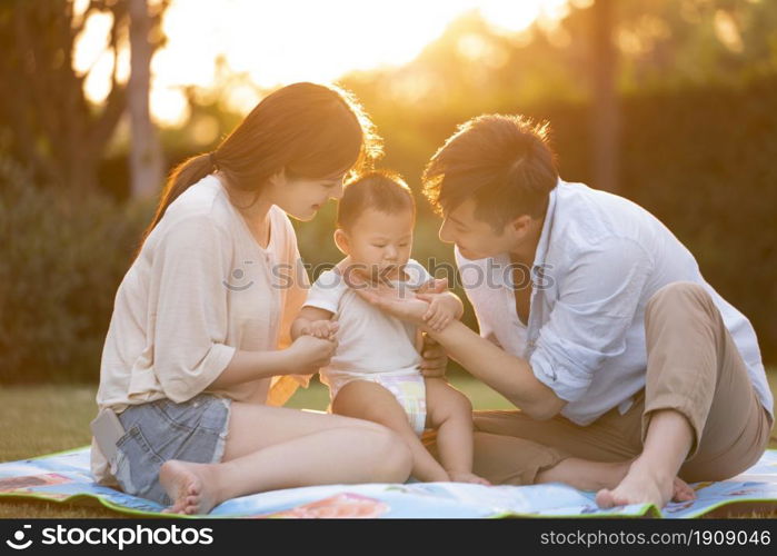 Loving and warm young family under the sunset