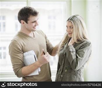 Loving business couple looking at each other in office