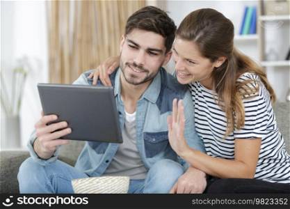 loving couple at home looking at tablet