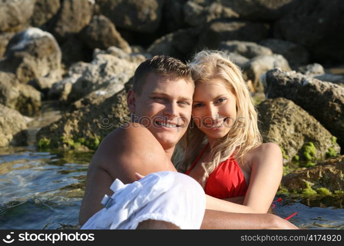 Loving couple at the beach in front of camera