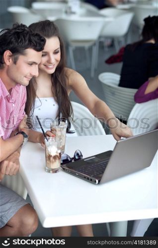 Loving couple browsing internet in a restaurant