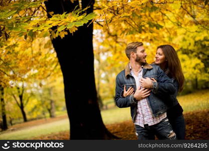 Loving couple exchanging tenderness in the autumn park