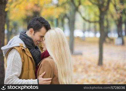Loving couple hugging in park