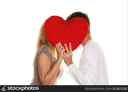 loving couple kissing behind a heart. love is beautiful. secret love