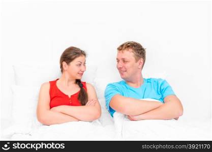 loving couple looking at each other in bed