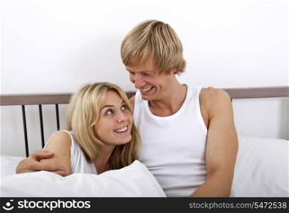 Loving couple looking at each other in bed
