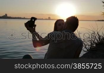Loving Couple On A Walk. Boy And Girl Kissing And Taking Pictures.