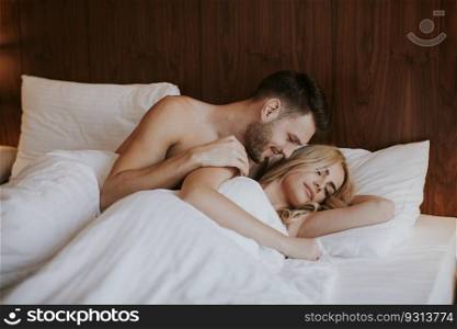 Loving couple on the bed in the bedroom