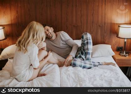 Loving couple on the bed in the bedroom