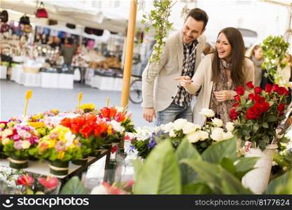 Loving couple picking flowers in Rome, Italy