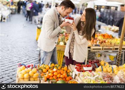 Loving couple picking fuits in Rome, Italy