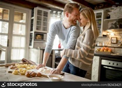 Loving couple preparing pasta in the kitchen at home