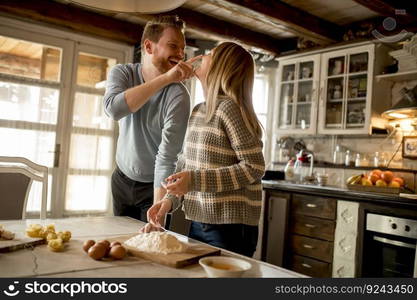 Loving couple preparing pasta in the kitchen at home