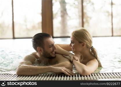 Loving couple relaxing at the spa center in  the  pool