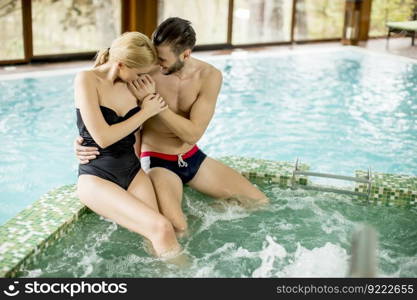 Loving couple relaxing in hot tub in spa