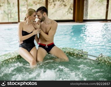 Loving couple relaxing in hot tub in spa