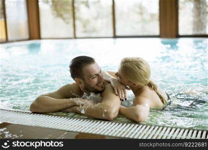 Loving couple relaxing in hot tub in spa