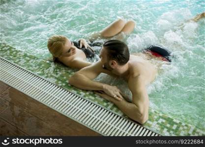 Loving couple relaxing in hot tub in spa