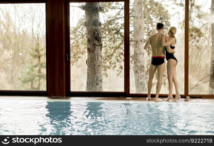Loving couple relaxing in the spa center by the  pool