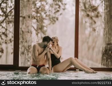 Loving couple relaxing in the spa center by the  pool